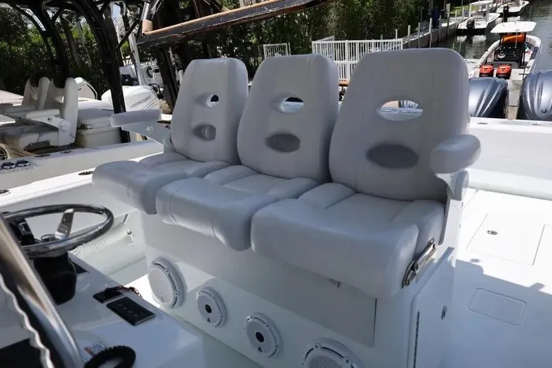 Slide: The Image of 2025 Contender 39 ST boat with luxurious white seating and modern steering console. - 10