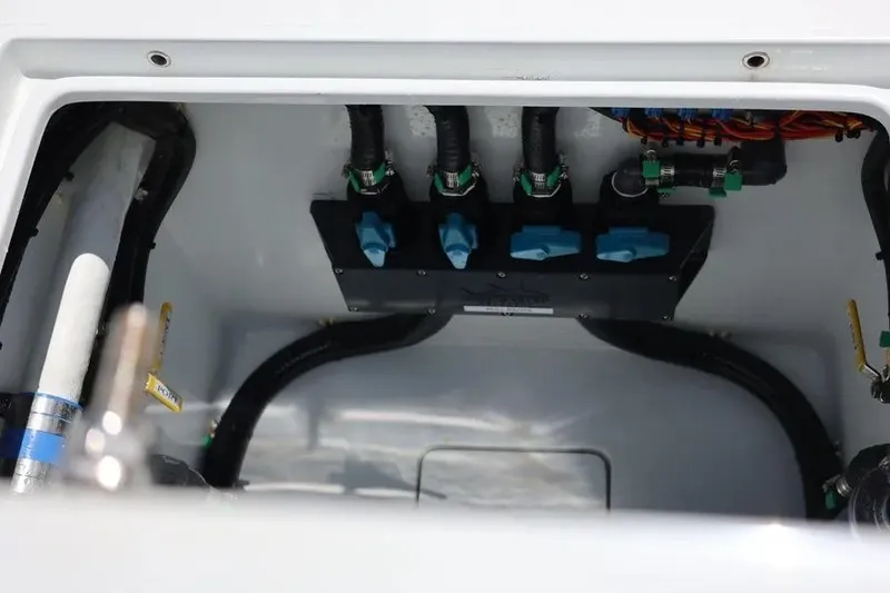 Slide: The Image of 2025 Contender 39 ST boat compartment with hoses and valves, showcasing internal components. - 16