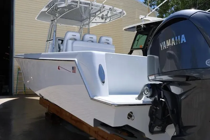 Slide: The Image of 2025 Contender 39 ST boat with Yamaha engine, docked in a sunny marina. - 3