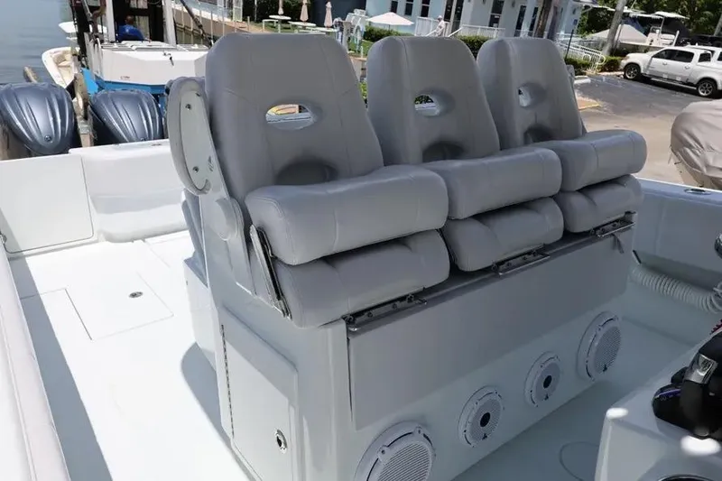 Slide: The Image of 2025 Contender 39 ST boat with three cushioned seats and marine speakers. - 5