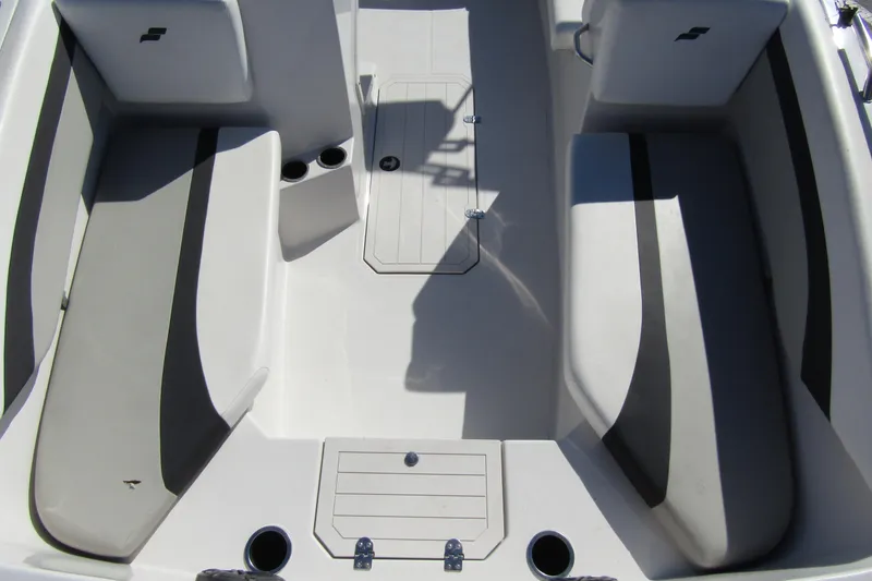 Slide: The Image of 2021 Starcraft SVX 171 OB boat interior with gray seating and storage compartments. - 10