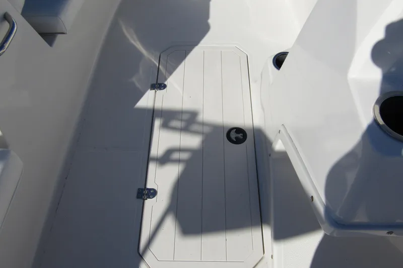 Slide: The Image of 2021 Starcraft SVX 171 OB boat interior with storage compartment and cup holders. - 17