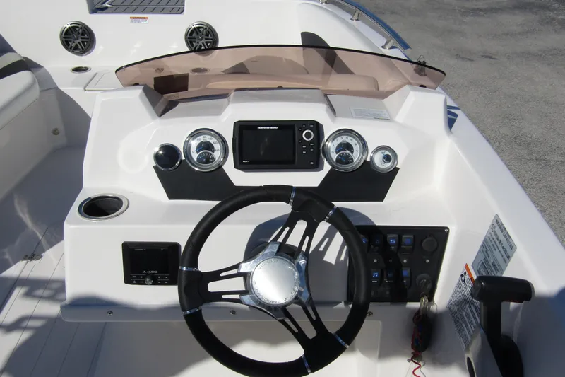 Slide: The Image of 2021 Starcraft SVX 171 OB boat dashboard with steering wheel and control panel. - 20