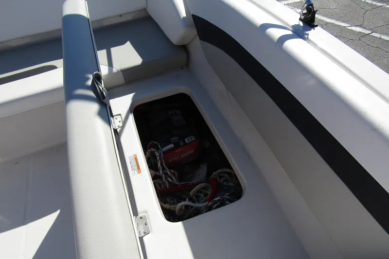 Slide: The Image of 2021 Starcraft SVX 171 OB boat storage compartment with battery and cables. - 26
