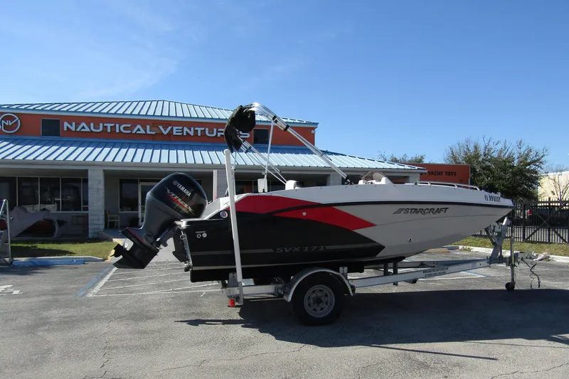 Slide: The Image of 2021 Starcraft SVX 171 OB boat on trailer outside Nautical Ventures store. - 4