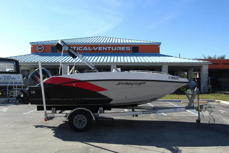 Slide: The Image of 2021 Starcraft SVX 171 OB boat on trailer outside Nautical Ventures store. - 5