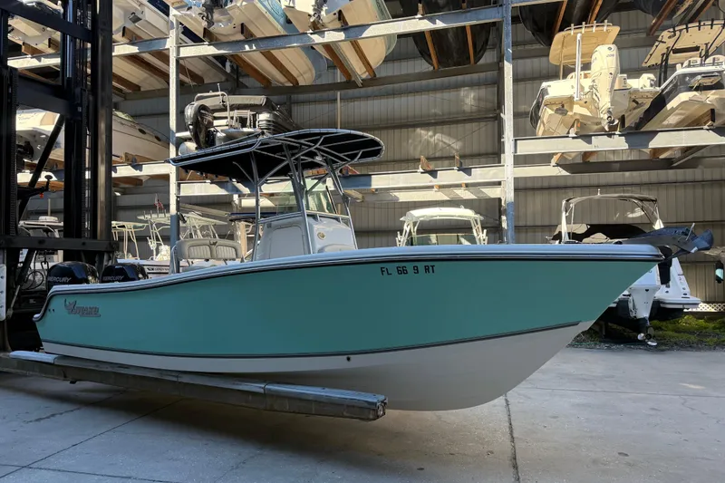 The Image of 2017 Mako 234 Center Console boat in storage facility with other boats. - 0