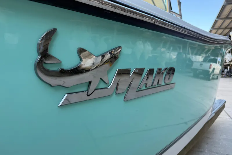 Slide: The Image of 2017 Mako 234 Center Console boat logo on turquoise hull. - 11