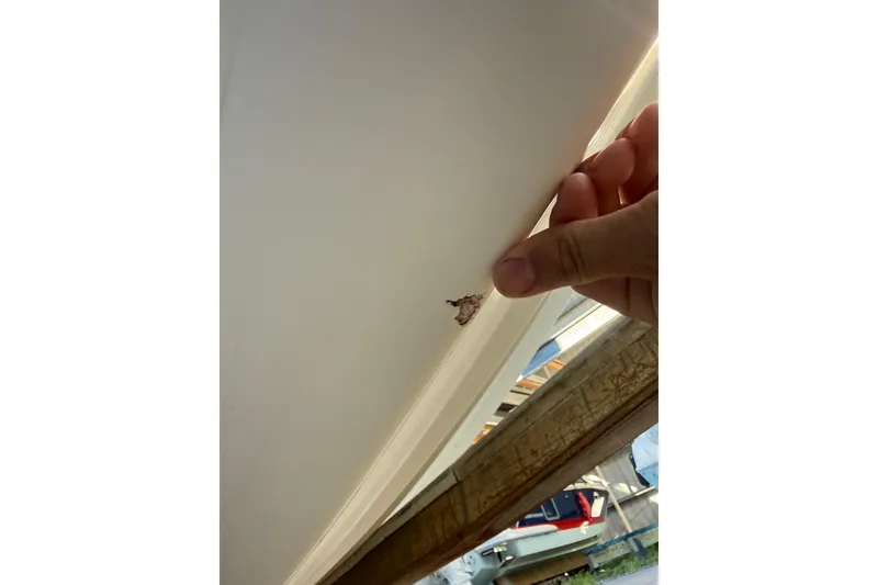 Slide: The Image of Close-up of damage on 2017 Mako 234 Center Console boat hull. - 15