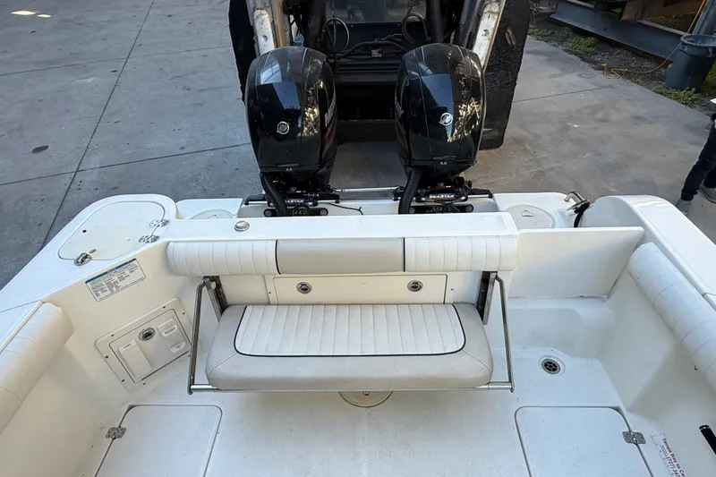 Slide: The Image of 2017 Mako 234 Center Console boat with dual outboard motors and seating area. - 16