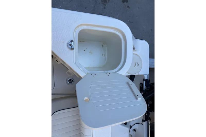 Slide: The Image of Open storage compartment on 2017 Mako 234 Center Console boat. - 18
