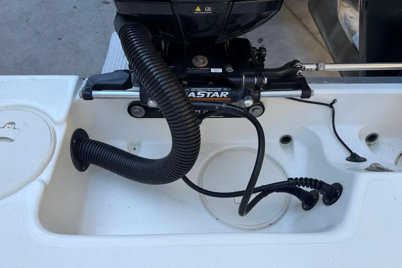 Slide: The Image of 2017 Mako 234 Center Console boat engine compartment with hydraulic steering system. - 19