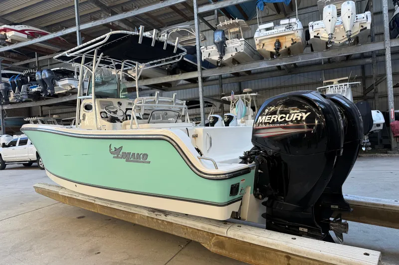 Slide: The Image of 2017 Mako 234 Center Console boat with Mercury engine in storage facility. - 2