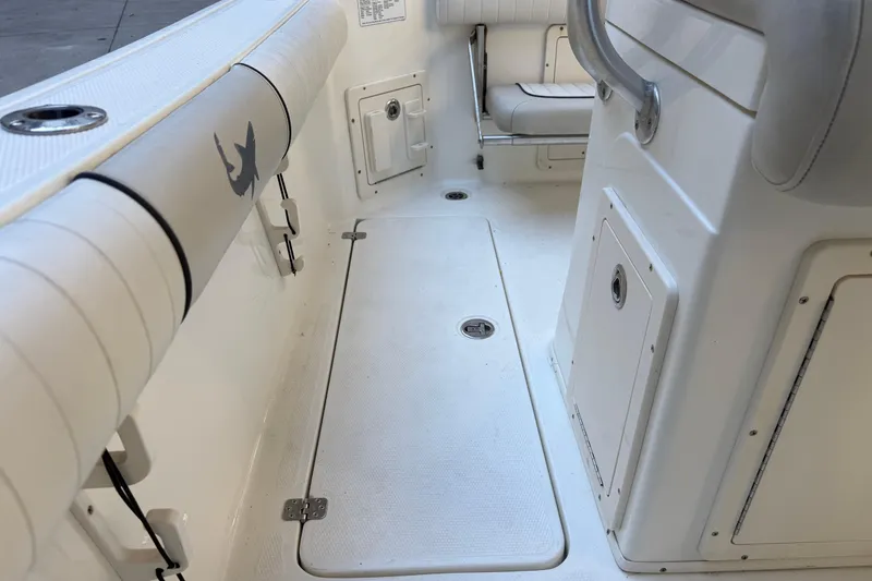 Slide: The Image of 2017 Mako 234 Center Console boat interior with storage compartments and seating. - 22