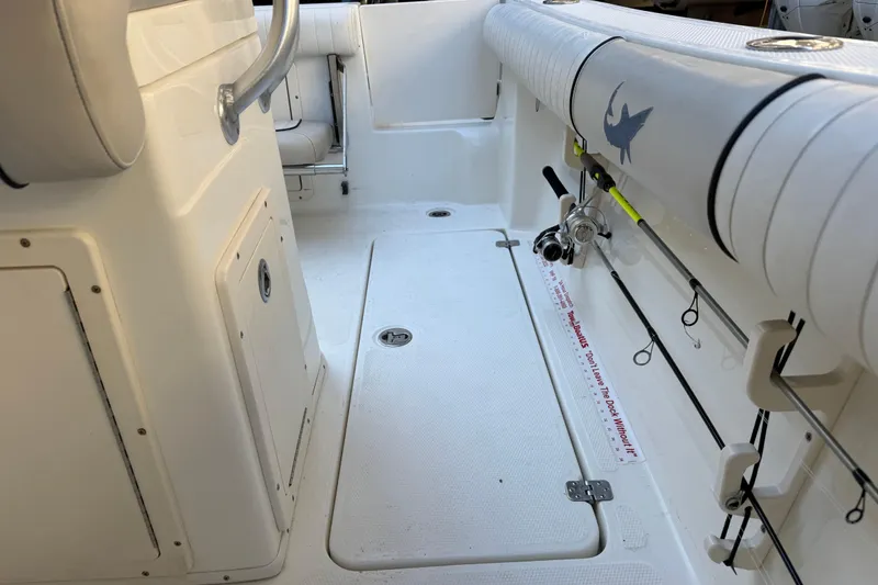 Slide: The Image of 2017 Mako 234 Center Console boat interior with rod holders and seating. - 23