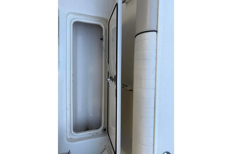 Slide: The Image of Open storage compartment on a 2017 Mako 234 Center Console boat. - 25