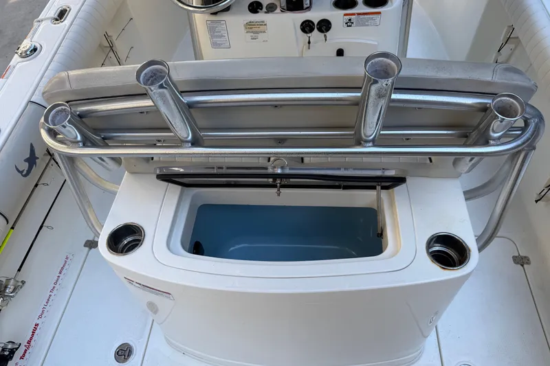 Slide: The Image of 2017 Mako 234 Center Console boat interior with rod holders and storage compartment. - 26