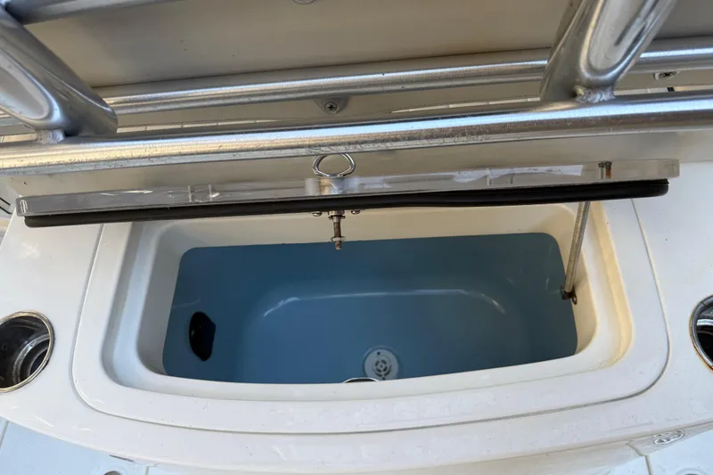 Slide: The Image of Open storage compartment on 2017 Mako 234 Center Console boat. - 27