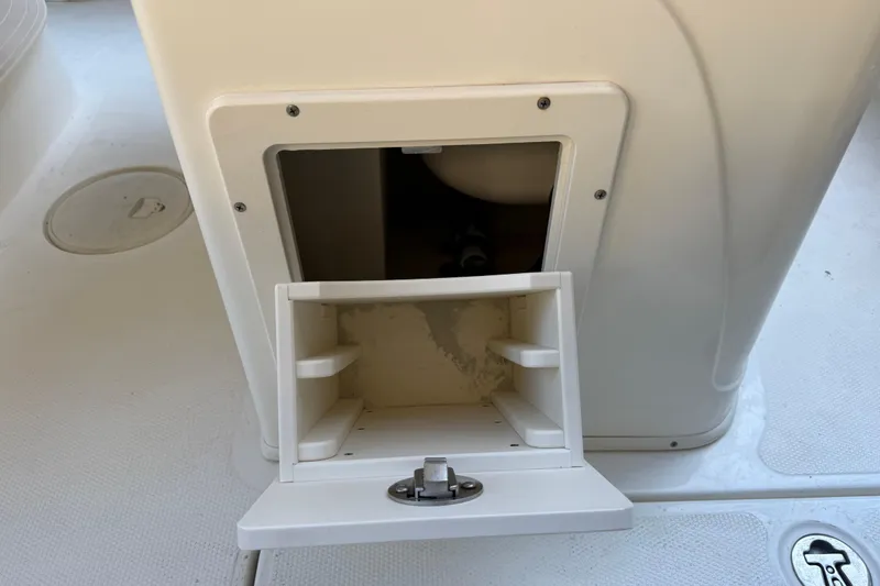 Slide: The Image of Open storage compartment on 2017 Mako 234 Center Console boat. - 29