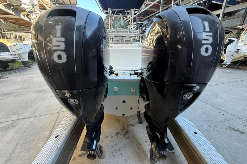 Slide: The Image of Twin 150 horsepower outboard engines on a 2017 Mako 234 Center Console boat. - 3