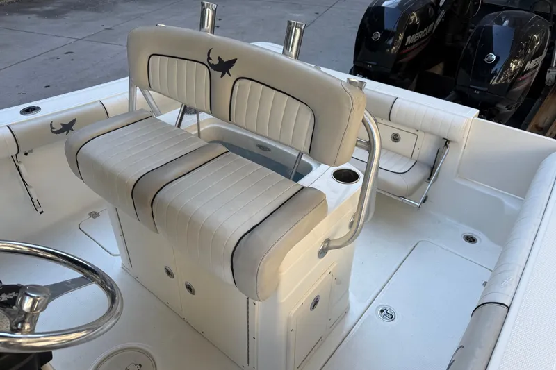 Slide: The Image of 2017 Mako 234 Center Console boat interior with seating and dual engines. - 30