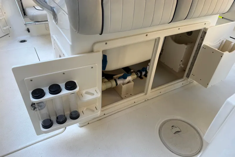 Slide: The Image of 2017 Mako 234 Center Console boat storage compartments and seating area. - 31