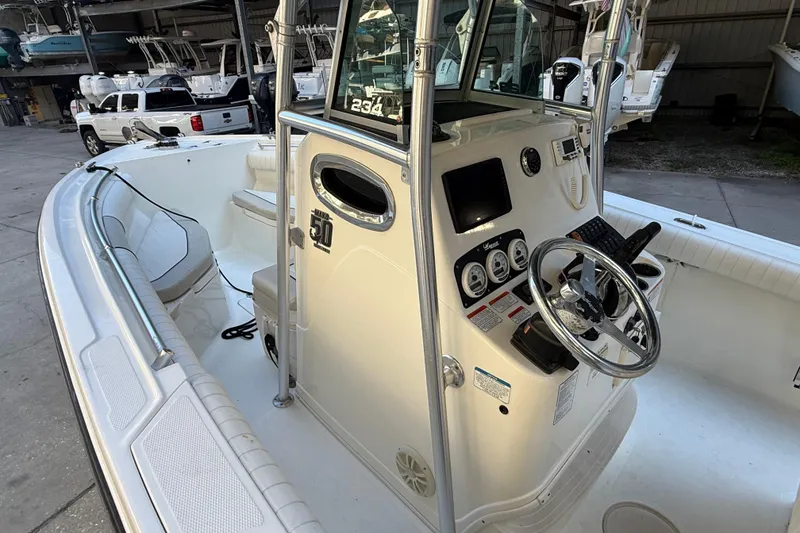 Slide: The Image of 2017 Mako 234 Center Console boat interior with steering wheel and control panel. - 32