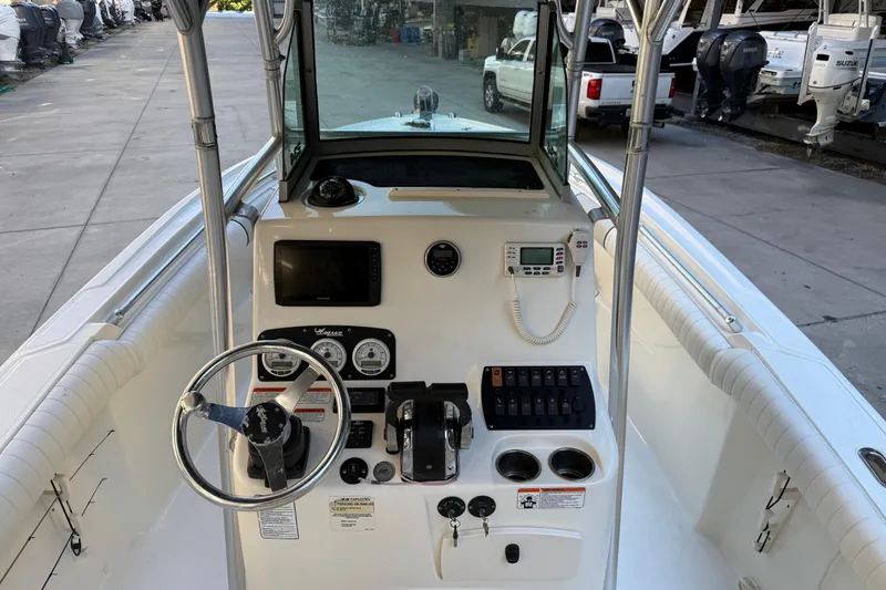 Slide: The Image of 2017 Mako 234 Center Console boat interior with steering wheel and control panel. - 33