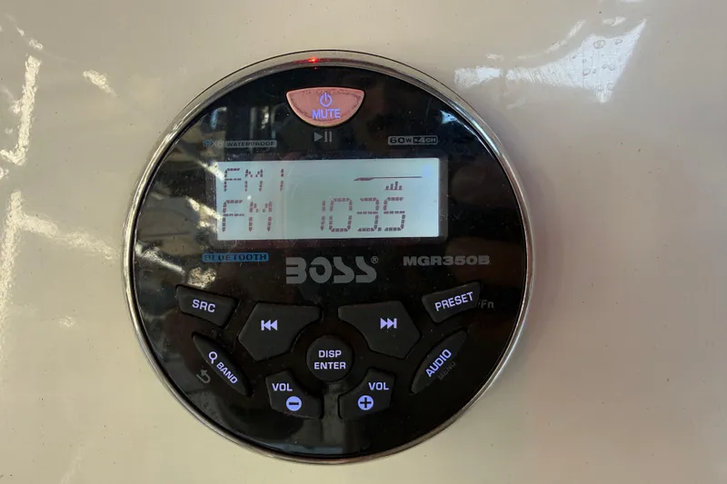 Slide: The Image of Boat stereo system displaying FM 103.5, installed on a 2017 Mako 234 Center Console. - 37