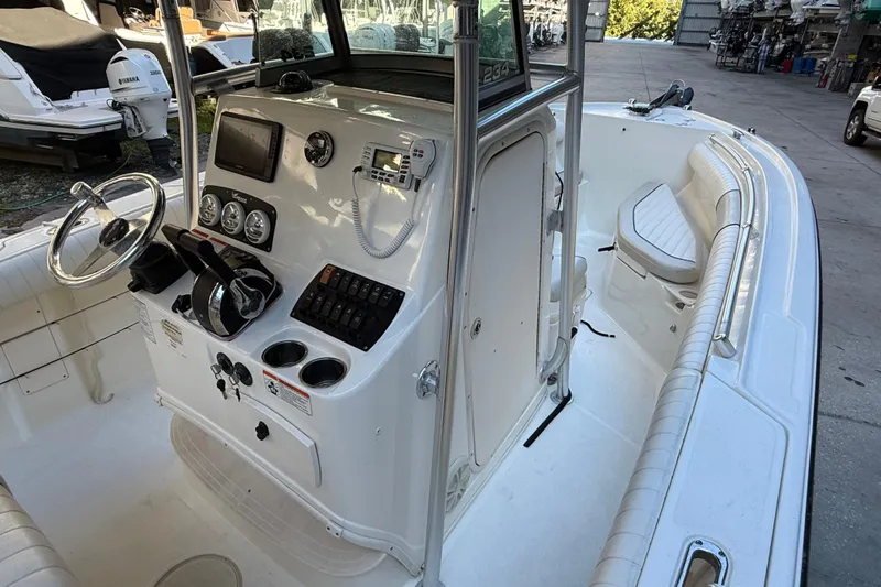 Slide: The Image of 2017 Mako 234 Center Console boat interior with steering wheel and control panel. - 39