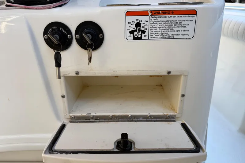 Slide: The Image of 2017 Mako 234 Center Console ignition panel with keys and carbon monoxide warning. - 41