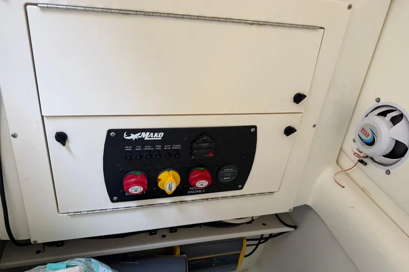 Slide: The Image of Control panel of a 2017 Mako 234 Center Console boat with switches and speaker. - 44