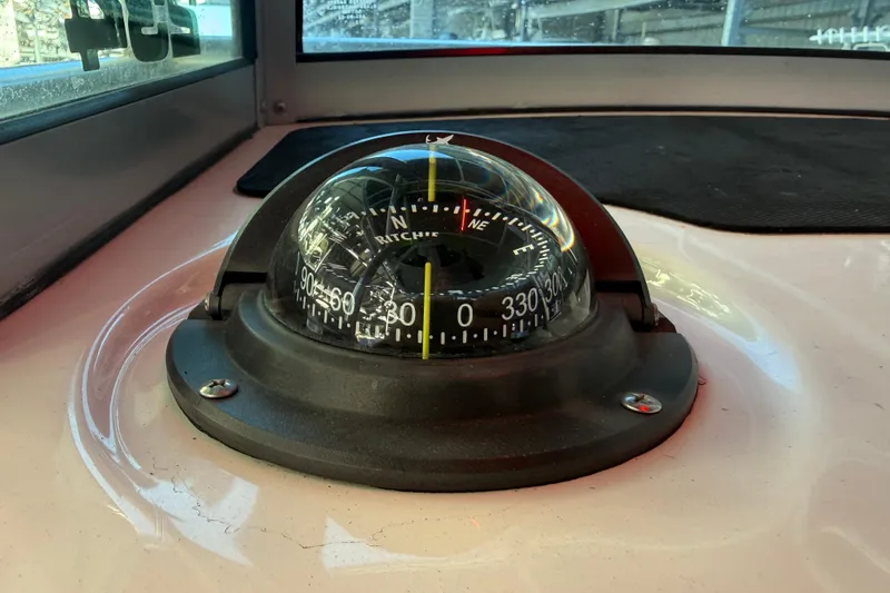 Slide: The Image of Compass on 2017 Mako 234 Center Console boat dashboard. - 45
