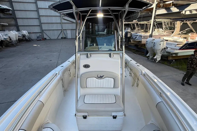 Slide: The Image of 2017 Mako 234 Center Console boat in a storage facility, showcasing seating and console. - 46