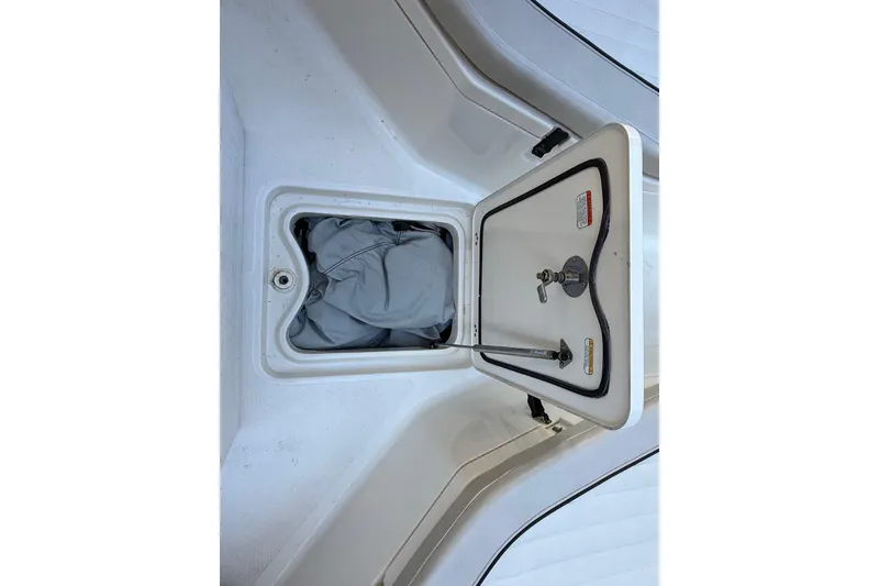 Slide: The Image of Open storage compartment on 2017 Mako 234 Center Console boat. - 51