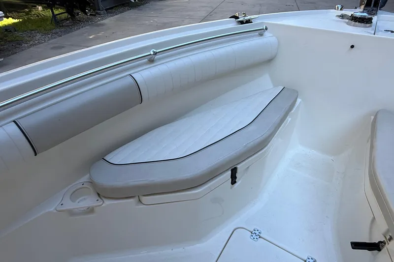 Slide: The Image of 2017 Mako 234 Center Console boat interior with cushioned seating and storage. - 52