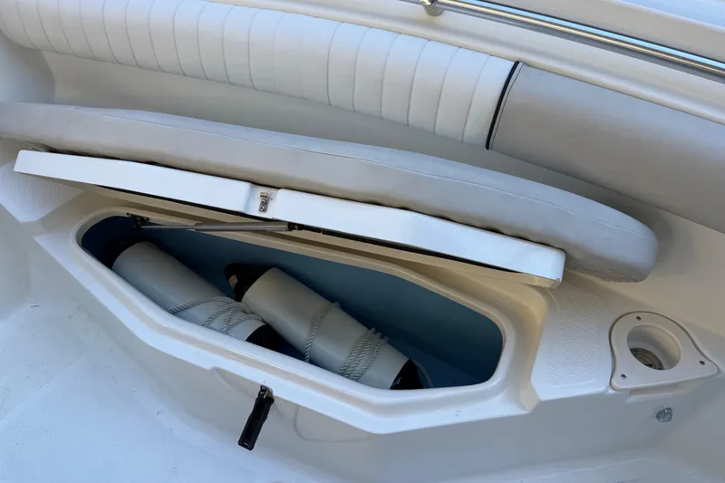 Slide: The Image of 2017 Mako 234 Center Console boat storage compartment with fenders and ropes. - 54