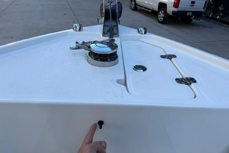 Slide: The Image of Bow of 2017 Mako 234 Center Console boat with anchor winch and storage compartments. - 55