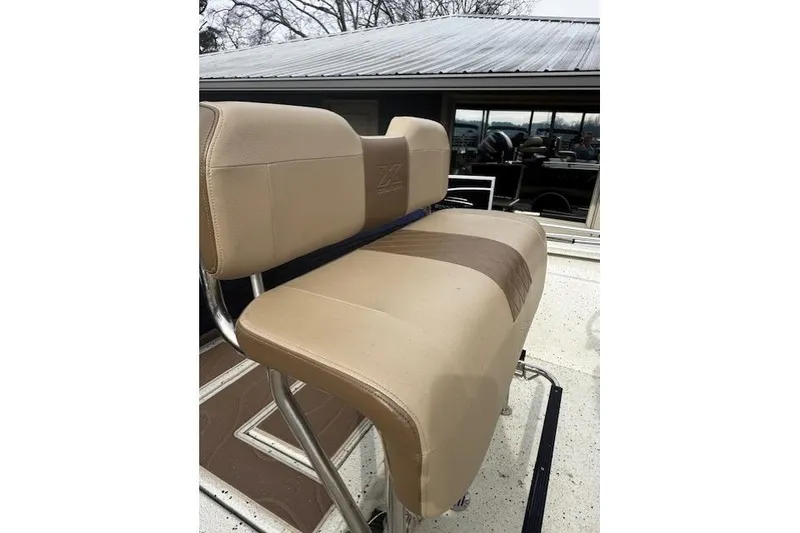 Slide: The Image of 2018 Xpress H20B Bay boat seat with tan upholstery and metal frame. - 4