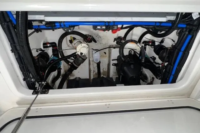 Slide: The Image of Engine compartment of a 2020 Boston Whaler 250 Outrage boat, showcasing mechanical components. - 10