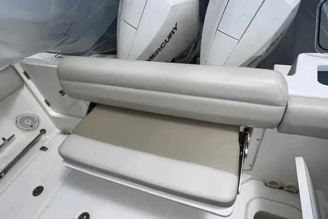 Slide: The Image of 2020 Boston Whaler 250 Outrage boat seating with Mercury engines in background. - 11
