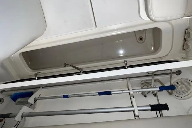 Slide: The Image of 2020 Boston Whaler 250 Outrage boat storage compartment with fishing gear. - 12