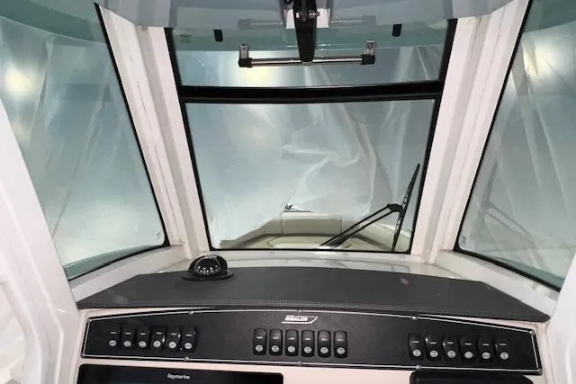 Slide: The Image of Cockpit view of 2020 Boston Whaler 250 Outrage boat with control panel and windshield. - 17