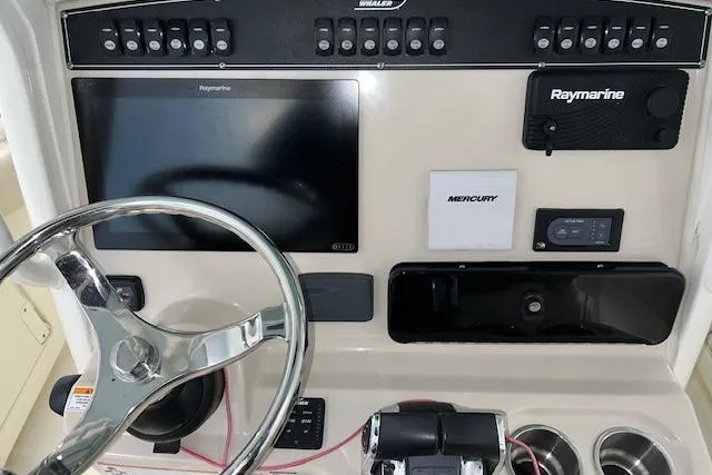 Slide: The Image of Control panel of 2020 Boston Whaler 250 Outrage with Raymarine electronics and Mercury controls. - 18