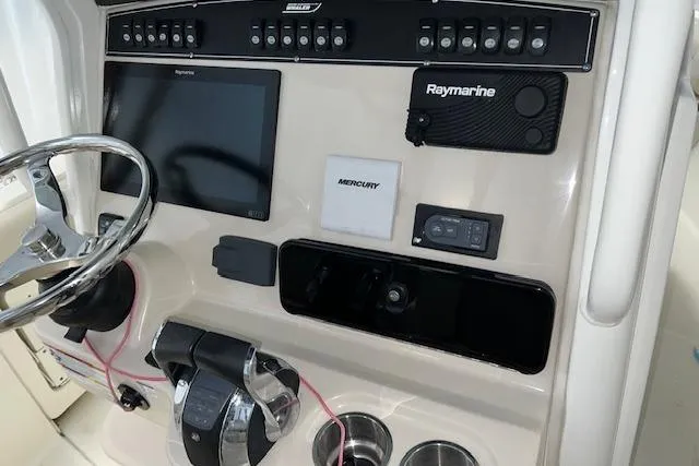 Slide: The Image of Control panel of 2020 Boston Whaler 250 Outrage with Raymarine electronics and Mercury controls. - 19