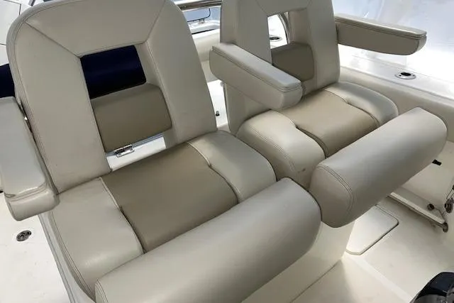 Slide: The Image of 2020 Boston Whaler 250 Outrage boat seats, featuring beige and cream upholstery. - 21