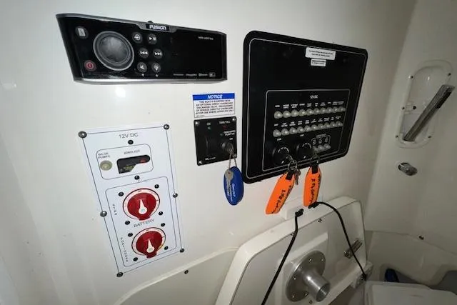 Slide: The Image of Control panel of a 2020 Boston Whaler 250 Outrage boat with switches and keys. - 23