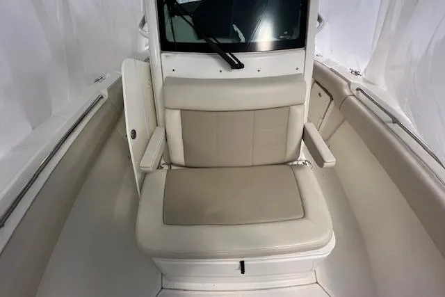 Slide: The Image of 2020 Boston Whaler 250 Outrage boat interior with cushioned seating and sleek design. - 25