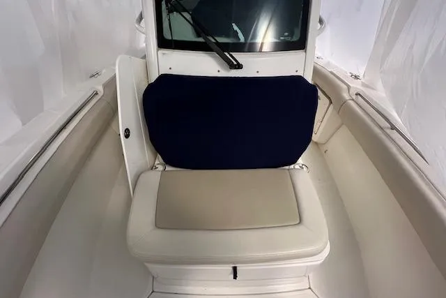 Slide: The Image of 2020 Boston Whaler 250 Outrage boat interior with cushioned seating and windshield. - 26