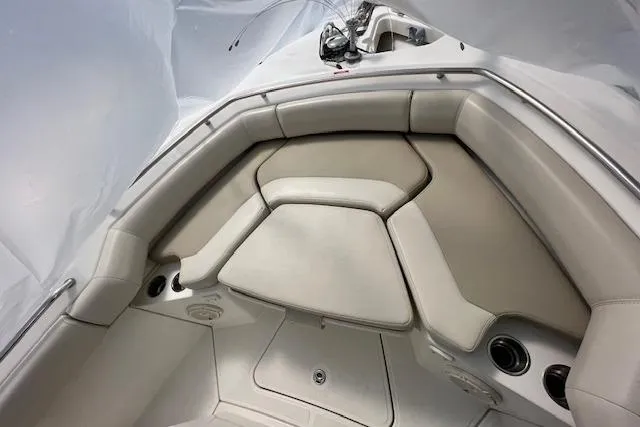 Slide: The Image of 2020 Boston Whaler 250 Outrage boat interior with cushioned seating and cup holders. - 29
